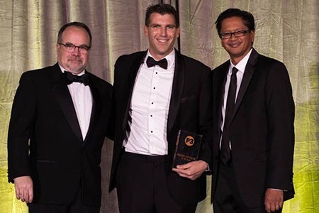 UC Merced Vice Chancellor for Planning and Budget Daniel Feitelberg, center, poses with others while holding his P3 Award.