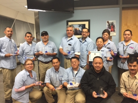 Members of the custodial staff pose with their service awards.