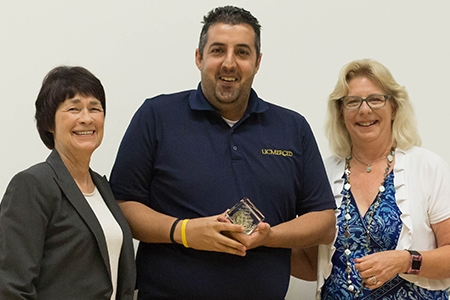 2016 Excellence Award winner Mort Peyvandi, center, stands between Chancellor Dorothy Leland and Staff Assembly President Pam Taylor.