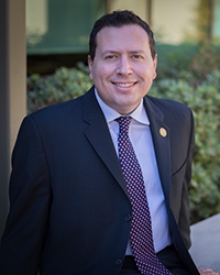 Assistant Vice Chancellor for Human Resources Brian Powell is seated outside at UC Merced.