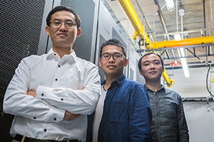Professor Dong Li and students Yingchao Huang, center, and Luanzheng Guo work on supercomputing efficiency.