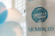 Balloons and a banner promote UC Merced's Giving Tuesday campaign.