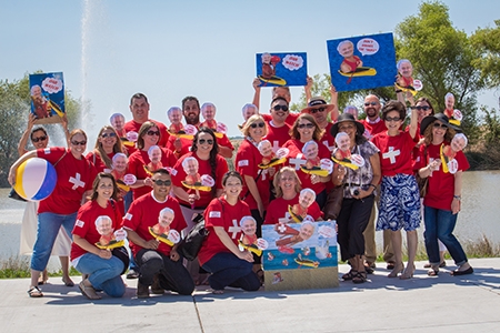 Staff members cheer at the kayak race during the 2014 Staff Appreciation Week.