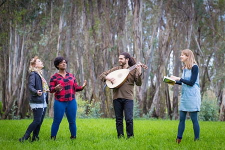 Two female performers sing as a lute player and UC Merced Professor Katherine Steele Brokaw look on.