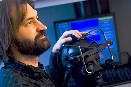 Professor Michael Spivey uses equipment such as this head gear to measure eye movements and collect data.