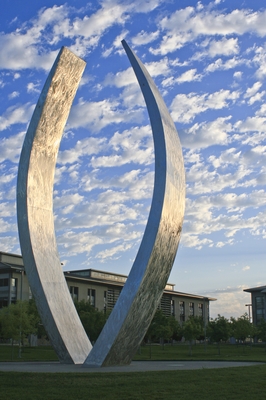 UC Merced's Beginnings sculpture is shown with the Classroom and Office Building in the background.