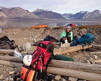 Professor Marilyn Fogel makes coffee on the shores of Billefjorden, Svalbard, nearby the Ebbadalen “blueberry” rock outcrop.