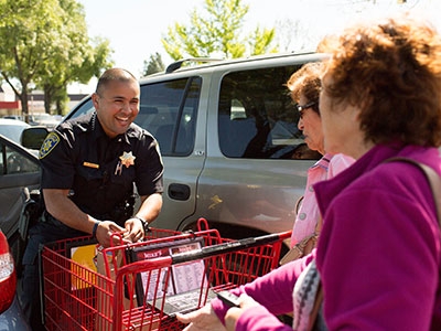 Law enforcement personnel bagged groceries and escorted customers to their car for donations.