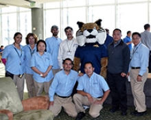Staff members pose with UC Merced mascot Rufus Bobcat during the Staff Appreciation Week breakfast.